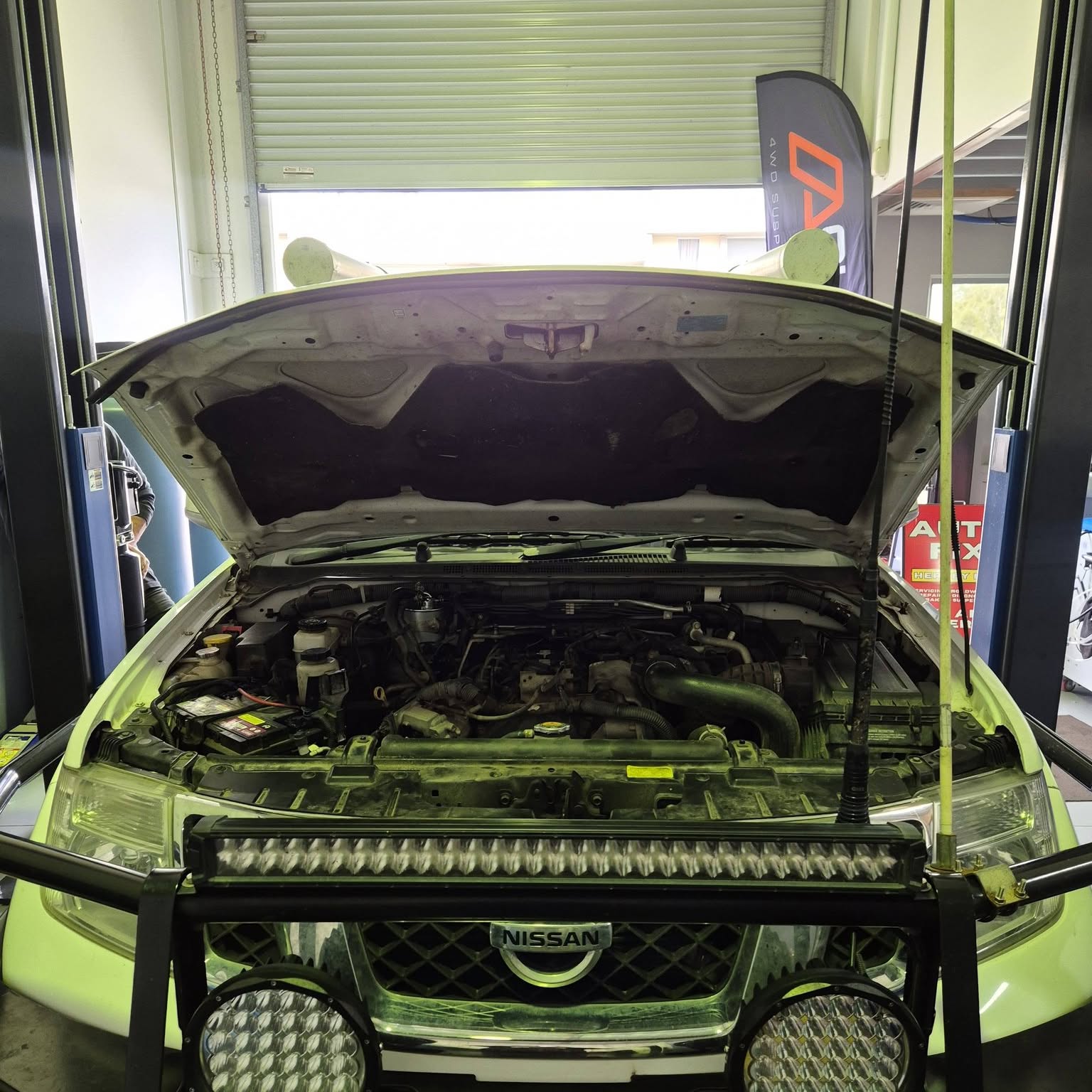 A four wheel drive with bullbar and light bar up on the hoist at Autofix Hervey Bay